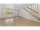 Bright, open living area with wood floors, featuring natural light, entryway, and staircase at 3212 Ramblewood N Dr # 3212, Sarasota, FL 34237