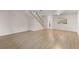 Expansive living room with wood floors, complemented by a staircase and a pass-through to the kitchen at 3212 Ramblewood N Dr # 3212, Sarasota, FL 34237