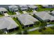 Aerial view of a home with a paved driveway, landscaping, and backyard at 3707 Wild Blossom Pl, Parrish, FL 34219