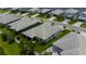 Aerial view of a home with a paved driveway, landscaping, and backyard at 3707 Wild Blossom Pl, Parrish, FL 34219