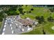 Aerial view of a golf course clubhouse with a large parking lot and well-manicured green spaces at 3707 Wild Blossom Pl, Parrish, FL 34219
