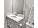 Bathroom with a large mirror above the vanity and light gray cabinetry at 3707 Wild Blossom Pl, Parrish, FL 34219
