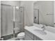Elegant bathroom featuring a glass-enclosed shower with pebble flooring and a modern vanity with stylish fixtures at 3707 Wild Blossom Pl, Parrish, FL 34219