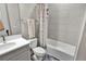 Cozy bathroom featuring a shower-tub combo, tile surround, and neutral tones at 3707 Wild Blossom Pl, Parrish, FL 34219