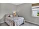 Comfortable bedroom with natural light, carpeted floors, a double bed, and neutral walls, creating a peaceful environment at 3707 Wild Blossom Pl, Parrish, FL 34219