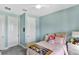 Bright bedroom featuring soft blue walls, carpeted floor, double closets, and comfortable twin bed at 3707 Wild Blossom Pl, Parrish, FL 34219
