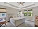 Spacious primary bedroom with a tray ceiling, plush carpeting, and natural light from multiple windows at 3707 Wild Blossom Pl, Parrish, FL 34219