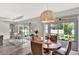 Inviting dining area with a charming light fixture, seamless access to outdoor patio, and beautiful backyard views at 3707 Wild Blossom Pl, Parrish, FL 34219