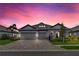Charming single-story home with brick-paved driveway, well-manicured landscaping and attached three car garage at 3707 Wild Blossom Pl, Parrish, FL 34219
