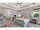 Beautiful main bedroom with ceiling fan, desk, and an ensuite bathroom featuring modern finishes and fixtures at 3707 Wild Blossom Pl, Parrish, FL 34219