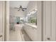 Bright bathroom with double sinks, white cabinetry, large mirrors, soaking tub, and walk-in shower at 4208 Balmoral Way, Sarasota, FL 34238