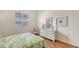 Bright bedroom features shuttered windows, wood floors, and white coastal-themed furniture at 4208 Balmoral Way, Sarasota, FL 34238