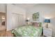 Bright bedroom featuring tropical bedding, charming decor, and closet storage at 4208 Balmoral Way, Sarasota, FL 34238