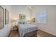 Comfortable bedroom features hardwood floors, paisley bedding, ample light, and a ceiling fan at 4208 Balmoral Way, Sarasota, FL 34238