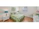 Bright bedroom features shuttered windows, wood floors, and coastal-themed decor at 4208 Balmoral Way, Sarasota, FL 34238