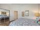 Comfortable bedroom with hardwood floors, closet with mirrored doors and an ensuite bathroom at 4208 Balmoral Way, Sarasota, FL 34238