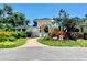 An arched entryway welcomes you to the community with lush landscaping and a brick path at 4208 Balmoral Way, Sarasota, FL 34238