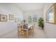 Bright and airy dining room with large window, simple furnishings, and tasteful decor at 4208 Balmoral Way, Sarasota, FL 34238