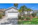 Charming single-story home with lush landscaping, a manicured lawn, and a two-car garage at 4208 Balmoral Way, Sarasota, FL 34238