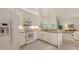 Bright kitchen features white cabinetry, granite counters, and modern appliances at 4208 Balmoral Way, Sarasota, FL 34238