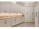 Well-appointed kitchen featuring white cabinetry, light countertops, and modern appliances at 4208 Balmoral Way, Sarasota, FL 34238