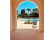 A glimpse of the refreshing community pool, framed by an arched entrance and lounge chairs at 4208 Balmoral Way, Sarasota, FL 34238