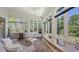 Bright sunroom with large windows offering lush garden views at 4208 Balmoral Way, Sarasota, FL 34238