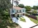 Aerial view of a two-story home that is elevated with large driveway at 4209 W Woodlawn Ave, Tampa, FL 33614