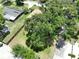 An aerial view of the property featuring mature trees and a fenced-in yard at 4209 W Woodlawn Ave, Tampa, FL 33614