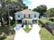 Aerial view of a two-story home with a large driveway and a fence in the back yard at 4209 W Woodlawn Ave, Tampa, FL 33614