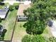 This aerial view showcases a well-maintained home with a spacious yard and mature trees at 4209 W Woodlawn Ave, Tampa, FL 33614