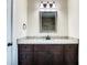 This bathroom's vanity features granite countertops and dark wood cabinets at 4209 W Woodlawn Ave, Tampa, FL 33614