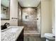 Bathroom featuring a single vanity with granite counters and a large, tiled shower at 4209 W Woodlawn Ave, Tampa, FL 33614