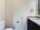 Bathroom features a granite counter top, dark wood cabinet, and a black towel ring at 4209 W Woodlawn Ave, Tampa, FL 33614