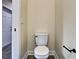 Clean bathroom features a white toilet, base trim, and light yellow paint at 4209 W Woodlawn Ave, Tampa, FL 33614
