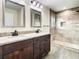 Bathroom featuring a double vanity with granite counters and a large, tiled shower at 4209 W Woodlawn Ave, Tampa, FL 33614