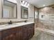 Bathroom featuring a double vanity with granite counters and a large, tiled shower at 4209 W Woodlawn Ave, Tampa, FL 33614
