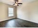 A sunlit bedroom with dark wood floors and a ceiling fan fixture at 4209 W Woodlawn Ave, Tampa, FL 33614