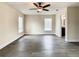 Bedroom featuring hardwood floors, two windows, a ceiling fan, and a bathroom at 4209 W Woodlawn Ave, Tampa, FL 33614