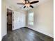 A sun-filled bedroom has dark wood floors and a closet with bifold doors at 4209 W Woodlawn Ave, Tampa, FL 33614