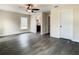 A Bedroom showing hardwood floors, ceiling fan, and a door to a bath room at 4209 W Woodlawn Ave, Tampa, FL 33614