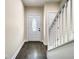 Bright foyer with a white front door featuring an oval glass insert and dark wood flooring at 4209 W Woodlawn Ave, Tampa, FL 33614