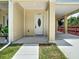 Close-up of duplex entryway highlighting covered parking, modern entrance door and adjacent lawn area at 4209 W Woodlawn Ave, Tampa, FL 33614