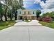 Charming two-story duplex with a large driveway, lawn, and quaint curb appeal on a sunny day at 4209 W Woodlawn Ave, Tampa, FL 33614
