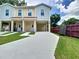Duplex with covered parking, meticulously maintained lawn, and easy access to both units at 4209 W Woodlawn Ave, Tampa, FL 33614