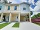 Modern duplex featuring convenient parking, covered entryways, and lush landscaping at 4209 W Woodlawn Ave, Tampa, FL 33614