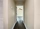 Hallway showing hard wood floors leading to a room with a ceiling fan at 4209 W Woodlawn Ave, Tampa, FL 33614
