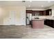 View of the modern kitchen that features stainless steel appliances and a center island with stone countertops at 4209 W Woodlawn Ave, Tampa, FL 33614