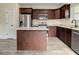Stylish kitchen with stainless steel appliances, granite counters, and a convenient center island at 4209 W Woodlawn Ave, Tampa, FL 33614