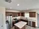 Spacious kitchen features stainless appliances, granite counters, kitchen island and modern cabinetry at 4209 W Woodlawn Ave, Tampa, FL 33614